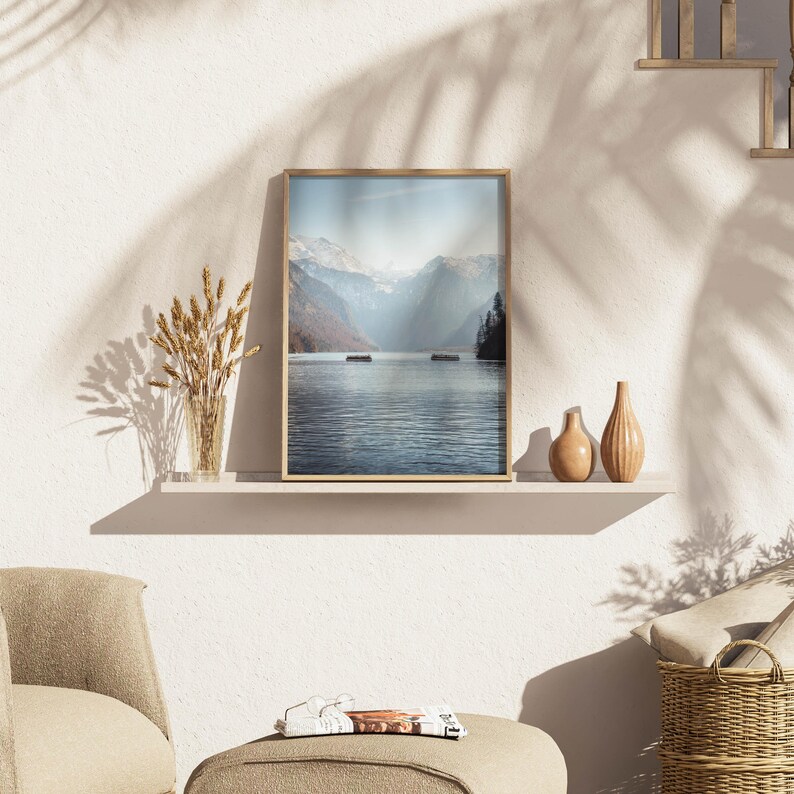 In a room, a framed Mountain Photography Print featuring the stunning Konigssee, Berchtesgaden.