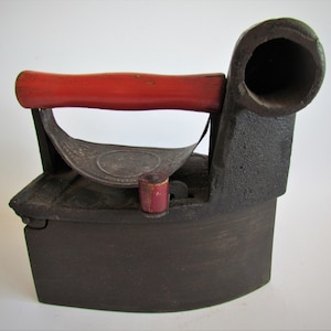 Vintage coal iron with pipe