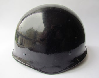 May include: A black helmet with a glossy finish and two small black rivets on the side.