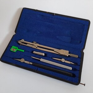 Peut inclure: Un coffret de compas argenté avec un taille-crayon vert et un étui de transport noir. Le coffret de compas comprend un compas, une règle et un crayon.