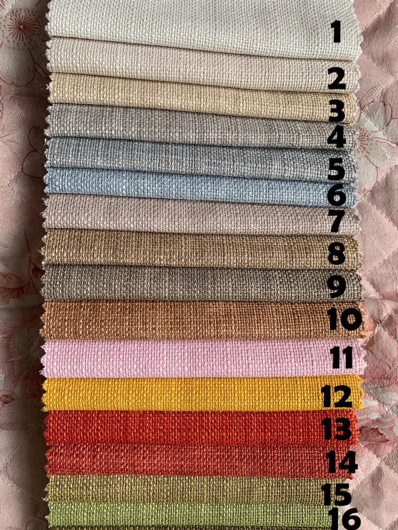 May include: A swatch card with 16 different fabric samples. The samples are arranged in rows, with each row numbered 1 through 16. The fabrics are a variety of colors and textures, including beige, brown, gray, blue, pink, yellow, orange, red, and green.