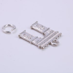 May include: Silver charm featuring a detailed design of an archway with a small loop at the bottom. A separate silver jump ring is also included.