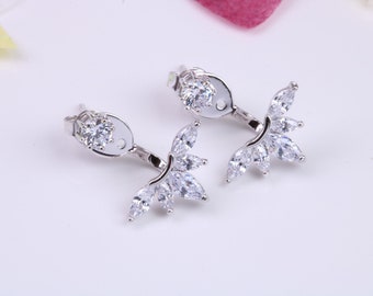 May include: A pair of silver earrings with a cluster of clear cubic zirconia stones in a leaf shape. The earrings are designed to be worn on the upper part of the ear.
