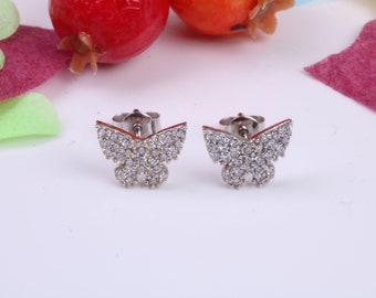May include: A pair of silver butterfly earrings with clear cubic zirconia stones.