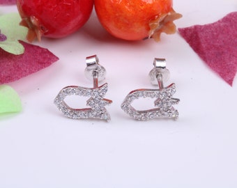 May include: A pair of silver earrings with a delicate design featuring a small, open circle with a pointed tip. The earrings are adorned with sparkling clear cubic zirconia stones.