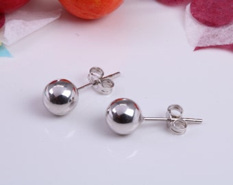 May include: A pair of silver ball stud earrings with a post and butterfly back.