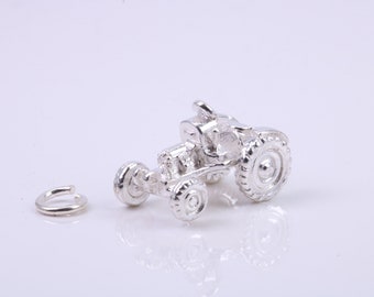 May include: A silver charm in the shape of a tractor. The charm has a loop for attaching to a bracelet or necklace.