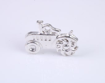 May include: Silver charm shaped like a tractor. The tractor has a detailed design with a wheel and a small chimney.