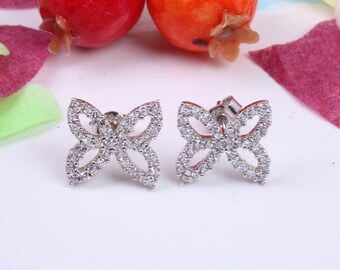 May include: A pair of silver butterfly earrings with clear cubic zirconia stones.