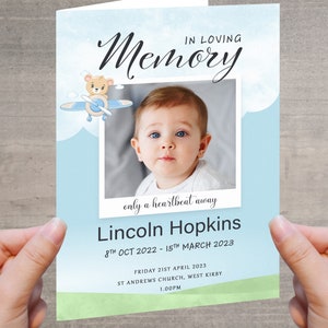 May include: A blue and green memorial card with a photo of a baby boy. The card has a teddy bear flying a plane and the text "In loving memory, only a heartbeat away, Lincoln Hopkins, 8th Oct 2022 - 15th March 2023, Friday 21st April 2023, St Andrews Church, West Kirby, 1.00pm."