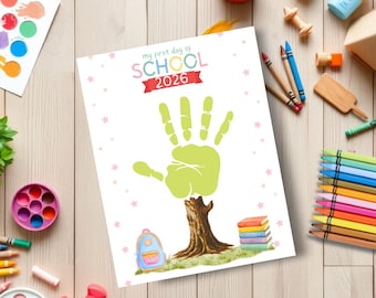 May include: A white paper sheet featuring the text 'my first day of SCHOOL 2026' in colorful letters. The design includes a large green handprint resembling a tree canopy atop a brown tree trunk, a small blue backpack, and a stack of colorful books.