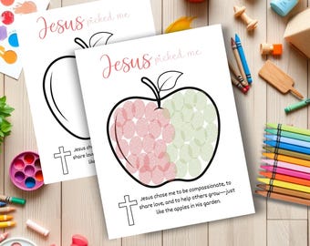 May include: Two white paper activity sheets featuring a black outline of an apple with the text Jesus picked me. One sheet shows a blank apple, while the other features an apple filled with red and green fingerprint art and religious text.