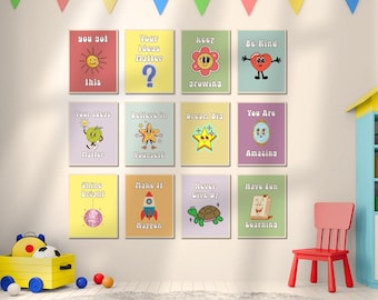 May include: A set of twelve rectangular wall art prints arranged in a grid, each featuring colorful cartoon illustrations and motivational text including phrases like You Got This, Your Ideas Matter, Keep Growing, Be Kind, and Dream Big.