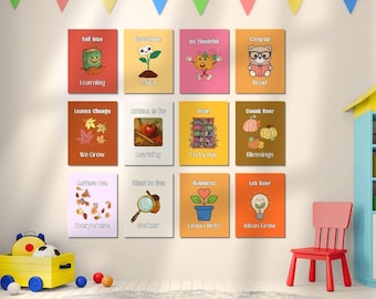 May include: A set of twelve rectangular wall posters arranged in a grid, each featuring colorful illustrations and text related to autumn themes, including a book, a plant, a pumpkin, a bear, leaves, an apple, a bookshelf, and a lightbulb.