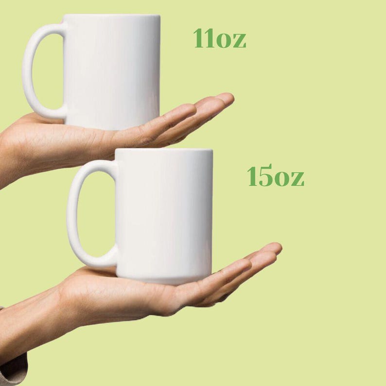 May include: Two white ceramic mugs, one 11oz and one 15oz, are held in front of a light green background. The mugs have a simple, cylindrical design with a curved handle. The text "11oz" and "15oz" is displayed in green.