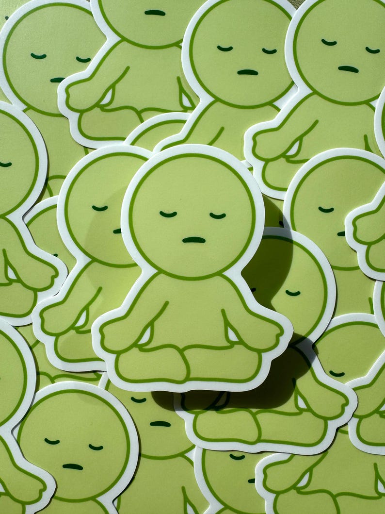 May include: A collection of green stickers featuring a cartoon character meditating with closed eyes. The character has a round head and a simple body with arms and legs.