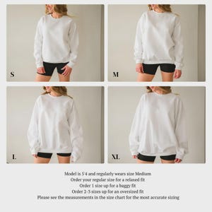 May include: Four images of a white sweatshirt in sizes S, M, L, and XL. The model is wearing black shorts. Text on the image states the model is 5'4" and wears a Medium. It also provides sizing recommendations for relaxed, baggy, and oversized fits.