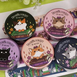 May include: Five rolls of washi tape featuring cats and books. Each roll has a different colour background and a different cat design. The text on the rolls reads "DOOMBLOOMART - 10 METERS - CATS & LITERATURE WASHI TAPE".