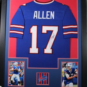 May include: Framed blue football jersey with the name "ALLEN" and the number "17" in white. The jersey is signed. Includes two action photos of the player and the team logo. The frame is black.