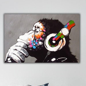 May include: A colorful abstract painting of a monkey wearing headphones. The monkey is in a thoughtful pose with its hand on its chin. The background is a light gray.