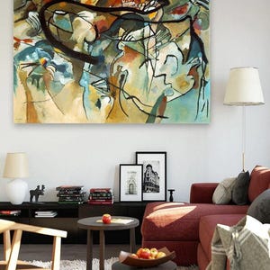 May include: A large rectangular canvas print featuring an abstract painting with fluid black lines, layered shapes, and a palette of muted blue, tan, ochre, and red tones. The artwork displays complex, non-representational forms and gestural brushwork.