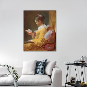May include: A painting of a woman in a yellow dress sitting in a chair and reading a book. She has a purple flower in her hair and is looking down at the book.