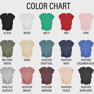 May include: A color chart displaying fifteen short-sleeve t-shirts in various colors including black, white, kelly green, red, pink, military green, sand, heather deep teal, heather navy, heather columbia blue, athletic heather, heather mauve, heather maroon, heather peach, and heather dark gray.