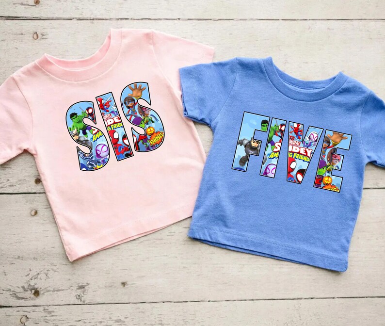 May include: Two t-shirts, one pink and one blue, with a Marvel superhero theme. The pink shirt says "SIS" with a Spiderman and other superhero characters. The blue shirt says "FIVE" with a Spiderman and other superhero characters.