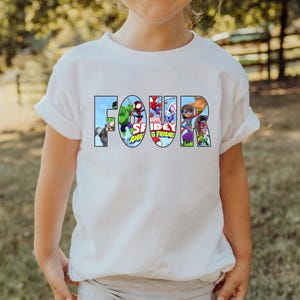 May include: White t-shirt with the word "FOUR" spelled out in colorful cartoon characters from the Marvel Spiderman and Friends animated series.