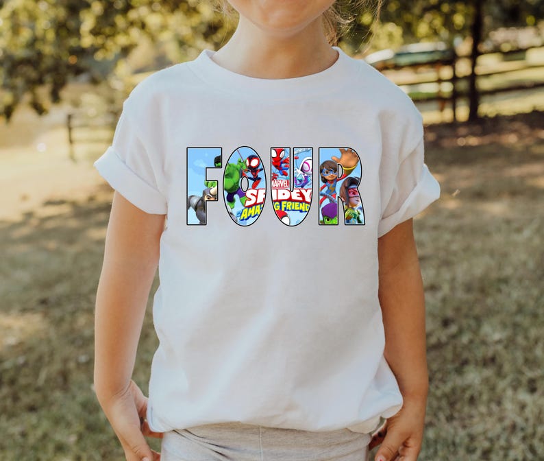 May include: White t-shirt with the word "FOUR" spelled out in colorful cartoon characters from the Marvel Spiderman and Friends animated series.