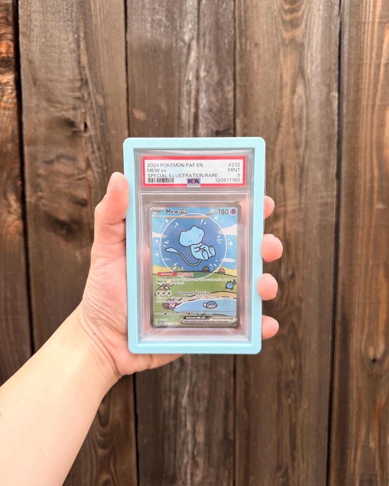 May include: A PSA graded 2024 Pokemon Mew ex Special Illustration Rare trading card, number 232, with a Mint 9 rating. The card is encased in a clear plastic slab with a light blue frame, displaying the character Mew in a blue circle.