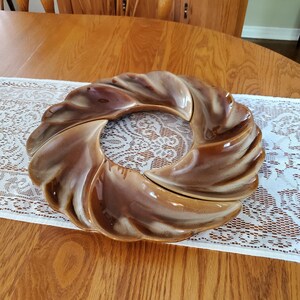 May include: A brown and white ceramic serving dish with a swirl design. The dish is divided into five sections.