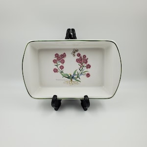 May include: White rectangular baking dish with a green rim and a floral design featuring pink flowers, green leaves, and a butterfly. The text "Dianthus Barbatus" is printed on the bottom of the dish.