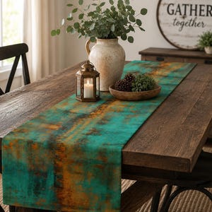 May include: A rectangular table runner featuring a distressed, oxidized metal aesthetic with vibrant teal and deep rust-orange color gradients. The fabric displays a textured, weathered pattern that runs along the length of the runner, creating a bold contrast.