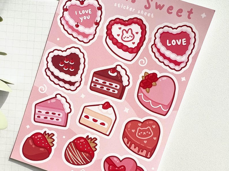 May include: A sheet of pink and red Valentine's Day stickers featuring various heart-shaped cakes and pastries with frosting, sprinkles, and cherries. The stickers say "I love you" and "Love".