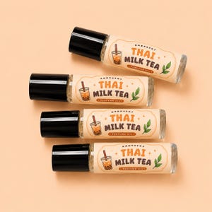 May include: Four clear glass rollerball perfume bottles with black caps, each featuring a cream-colored label with the text "Ondocent Thai Milk Tea Perfume Oil" and a small illustration of a boba tea drink with a straw and two green leaves.