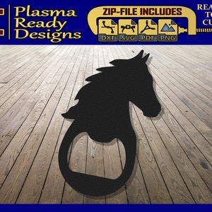 May include: Black metal horse head bottle opener. The bottle opener is on a wood background.