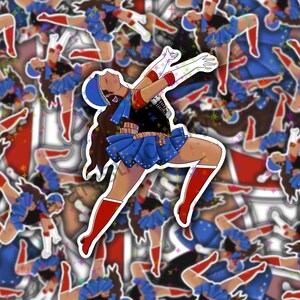 May include: A sticker featuring a cartoon illustration of a woman in a blue and red sailor outfit with a star pattern. She is jumping with her arms raised in the air. The background is a pattern of the same sailor girl stickers.