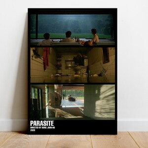 May include: A black and white poster with three scenes from the movie Parasite. The top scene shows three people sitting on a patio. The middle scene shows a hallway with a red shirt hanging on a hook. The bottom scene shows a room with a window and a car parked outside. The poster has the title "Parasite" and the text "Directed by Bong Joon-ho 2019" at the bottom.
