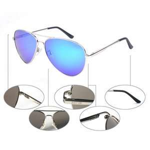 May include: Silver aviator sunglasses with blue mirrored lenses. The sunglasses have a black temple and a "JUST GO" inscription on the arm.