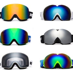 May include: Five pairs of ski goggles with different coloured lenses. The goggles have a black frame and a white strap with the words "Just Go" printed on them.