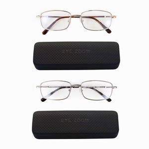May include: A pair of silver-toned reading glasses with clear lenses and a black case with the text "EYE ZOOM" on it.
