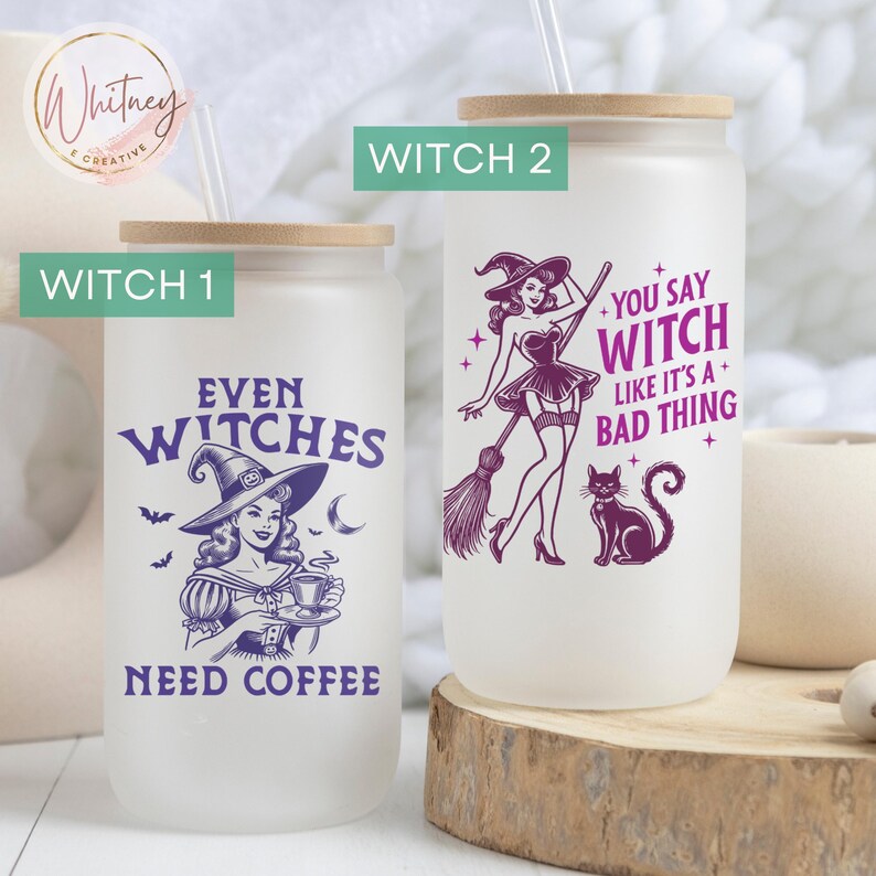 May include: Two frosted glass tumblers with a straw and a wooden lid. The tumbler on the left has a purple witch with a hat and the text "Even Witches Need Coffee". The tumbler on the right has a purple witch with a broom and the text "You Say Witch Like It's A Bad Thing".