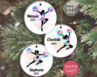 May include: Three round Christmas ornaments with cheerleader designs. Each ornament features a black silhouette of a cheerleader with colorful pom-poms and a skirt. The ornaments are personalized with names and the year 2025.
