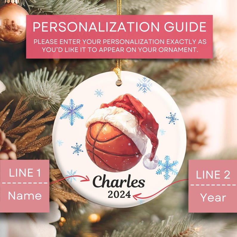 May include: White ceramic Christmas ornament with a basketball wearing a Santa hat. The ornament is decorated with snowflakes and the text "Charles 2024".