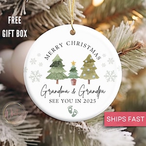 May include: White ceramic Christmas ornament with three green watercolor trees, a gold star, and the text "Merry Christmas Grandma & Grandpa See You in 2025" with two footprints below.