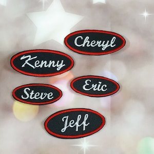 May include: Five black oval-shaped embroidered patches with red trim and white lettering. The names Cheryl, Kenny, Steve, Eric, and Jeff are on the patches.