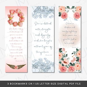 May include: Three printable bookmarks with floral designs and inspirational quotes. The first bookmark features a pink floral wreath with the quote "She extends a helping hand to the poor and opens her arms to the needy. The widow stands and blesses her; her husband praises her." The second bookmark features a blue floral design with the quote "She is clothed with strength and dignity, and she laughs without fear of the future." The third bookmark features a pink floral design with the quote "Charm is deceptive, and beauty is fleeting, but a woman who fears the Lord is to be praised."