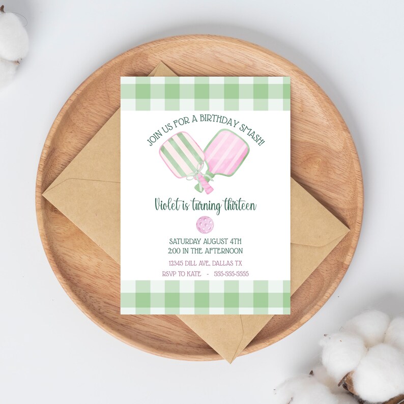 May include: A birthday invitation with a green and white gingham border. The invitation reads "Join us for a birthday smash! Violet is turning thirteen." The invitation is on a wooden plate with a brown envelope.