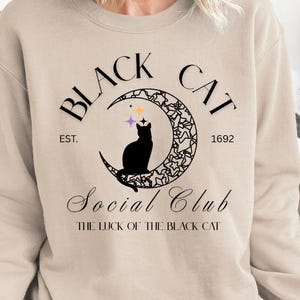 Black Cat Social Club Sweatshirt – Cat on Crescent Moon Logo, Mysterious Vintage Charm, Cozy Black Cat Halloween Sweatshirt, Cat Lover Gift